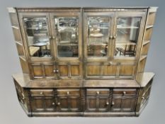 An Ercol stained elm four section wall cabinet,