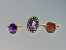 A 9ct gold amethyst ring, similar garnet ring and a silver ring.