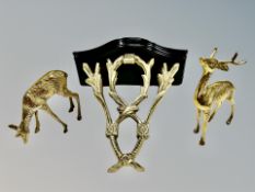 A brass and wood clock bracket and pair of brass figures of deer