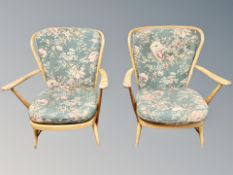 A pair of Ercol elm and beech spindle backed armchairs with floral cushions