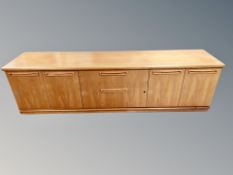 A teak G-Plan wall unit base fitted with cupboards and drawers,