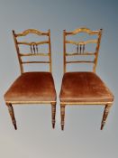 A pair of late Victorian rosewood and satinwood inlaid ladder backed salon chairs