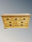 A Oak Furniture Land contemporary oak seven drawer low sideboard,