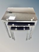 A contemporary nest of three glass and chrome tables,