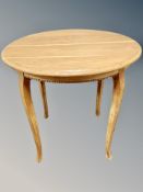 A circular oak occasional table