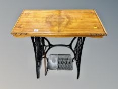 A Singer treadle sewing machine table with walnut top,