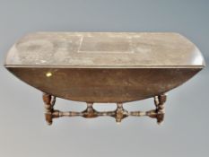 An Ercol stained elm drop leaf coffee table