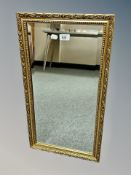 A contemporary gilt and bevelled mirror,