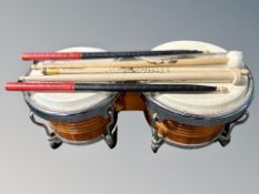 Two hand drums and a group of drum sticks,