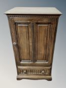 An Ercol stained elm single door cupboard,
