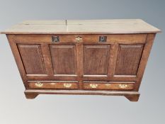 A George III panelled oak mule chest, fitted two drawers,