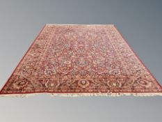 A machine made Persian style carpet on red ground,