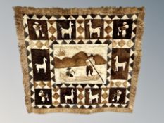 A continental fur wall hanging, depicting farmers and animals,
