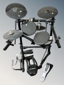 A Roland electronic drum kit and three pedals