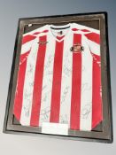 A Sunderland AFC football shirt in frame bearing signatures