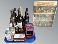 A collection of alcohol miniatures in enamelled metal display stand,