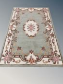 A machine made Chinese carpet on green ground,