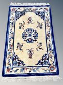 A Chinese rug on blue and beige ground 187 cm x 109 cm