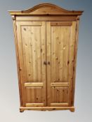 A contemporary pine double door wardrobe,