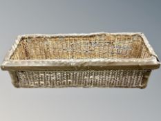 A wicker and leather storage basket,