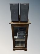 An Ercol stained elm entertainment cabinet containing a Technics hifi system and a pair of speakers