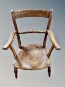 A 19th century elm kitchen armchair