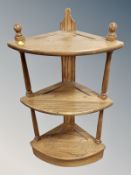 An Ercol stained elm three tier corner stand