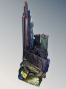 A group of fishing equipment including rods, folding chairs, landing net,
