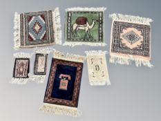 A group of seven miniature Eastern hearth rugs and prayer mats,