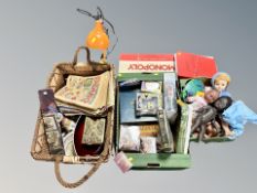 Two boxes and wicker basket of collectables, dolls, board games, stamp collection,
