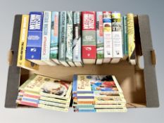 A box of Enid Blyton and Alistair Maclean novels