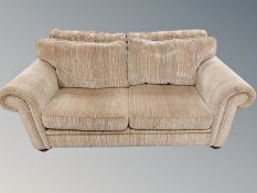 A three seater settee in striped fabric,