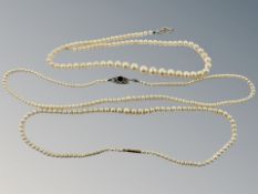 A graduated pearl necklace on yellow gold clasp, together with two further cultured pearl necklaces.