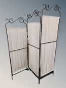 A wrought metal fabric room divider