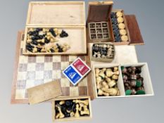 Four boxwood chess sets, two boards, draughts,