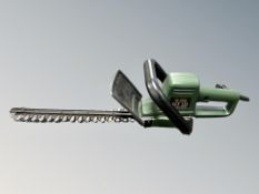 A Black and Decker hedge trimmer together with two extension leads