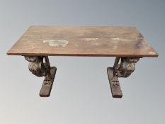 A rectangular low side table on carved supports,
