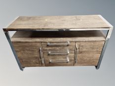 A contemporary chrome and rosewood effect entertainment sideboard,