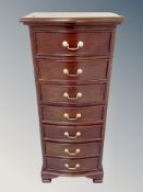 A reproduction slim chest of seven drawers,