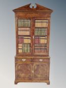 A good quality burr elm bookcase in the George III style fitted with double door cupboard and