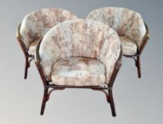 A set of three wicker conservatory armchairs