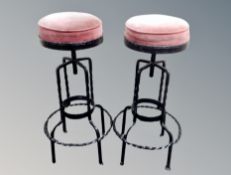 A pair of wrought iron stools