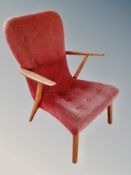 A Danish teak armchair in buttoned red fabric