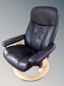 A Danish black stitched leather upholstered swivel armchair on beech support
