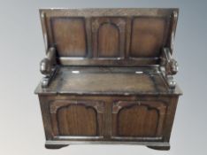 A carved oak monk's bench,