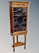 A reproduction mahogany astral glazed corner cabinet on stand