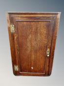 A George III oak hanging corner cabinet