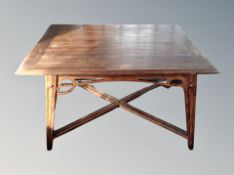 A 19th century oak table with X-frame under stretcher,