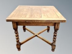 An Edwardian oak barley twist extending dining table, length 153 cm,