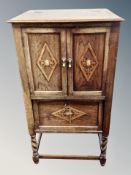 An Edwardian oak cabinet,